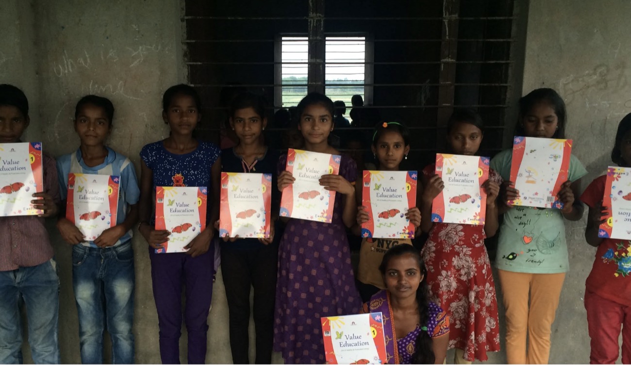Students with their new value-education workbooks