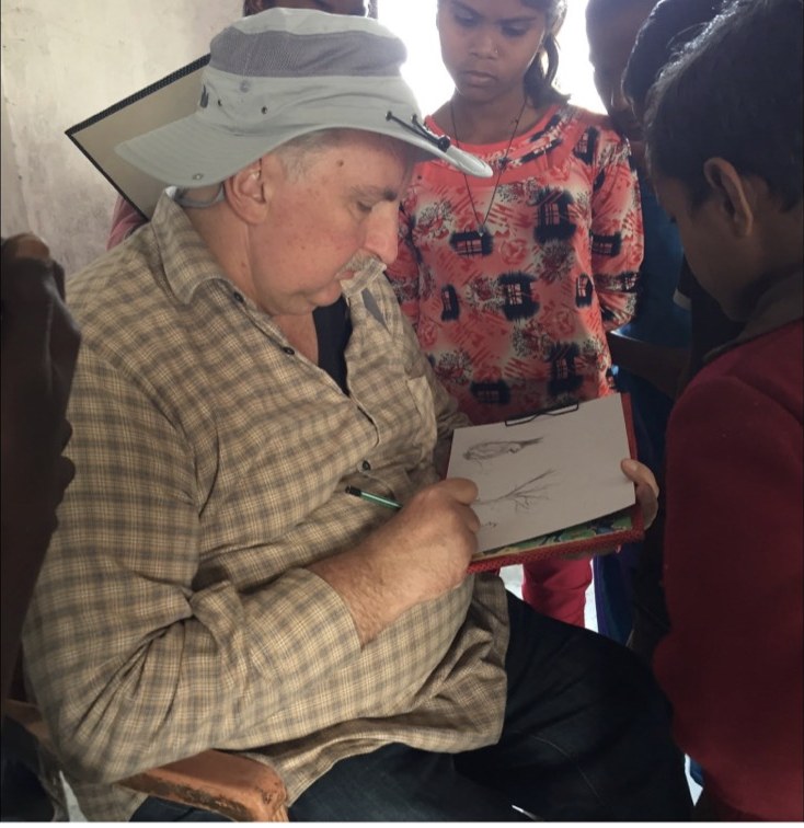 A volunteer teaching a sketching technique